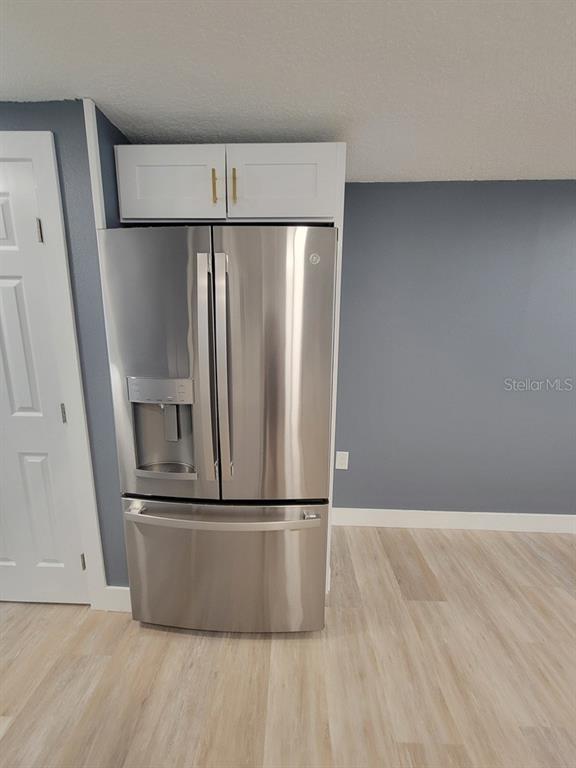 4944 Elkner Street New Port Richey, FL 34652 - Photo 10 of 24 a view of a refrigerator in kitchen and stainless steel appliances