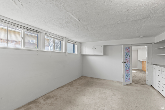 180 South 300 East Logan, UT 84321 - Photo 27 of 35 Basement featuring light carpet and a textured ceiling