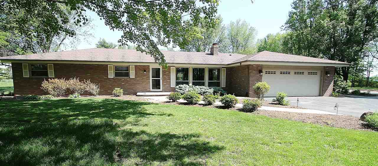 8372 Spring Creek Road Rockford, IL 61114 - Photo 1 of 25 a front view of a house with garden