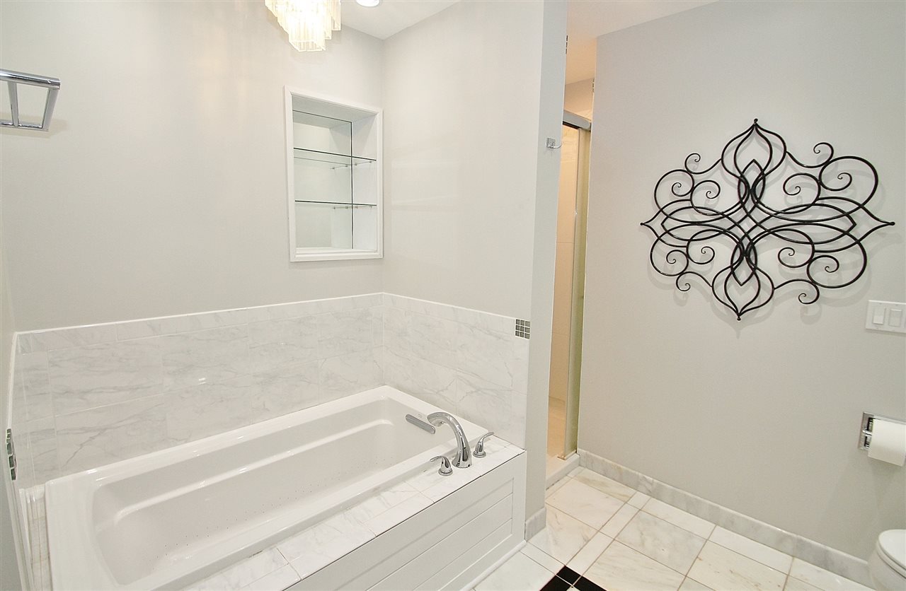 8372 Spring Creek Road Rockford, IL 61114 - Photo 16 of 25 a bathroom with a bathtub and shower
