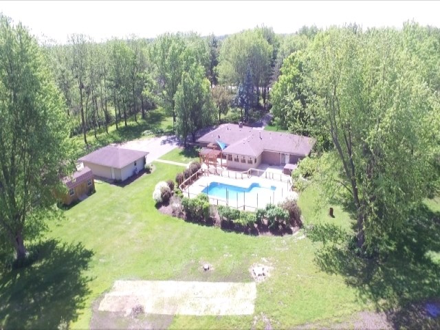8372 Spring Creek Road Rockford, IL 61114 - Photo 25 of 25 a view of a swimming pool in he middle of the green field
