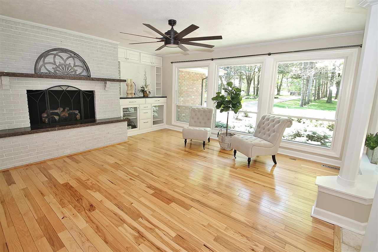 8372 Spring Creek Road Rockford, IL 61114 - Photo 3 of 25 a living room with furniture a window and a fireplace