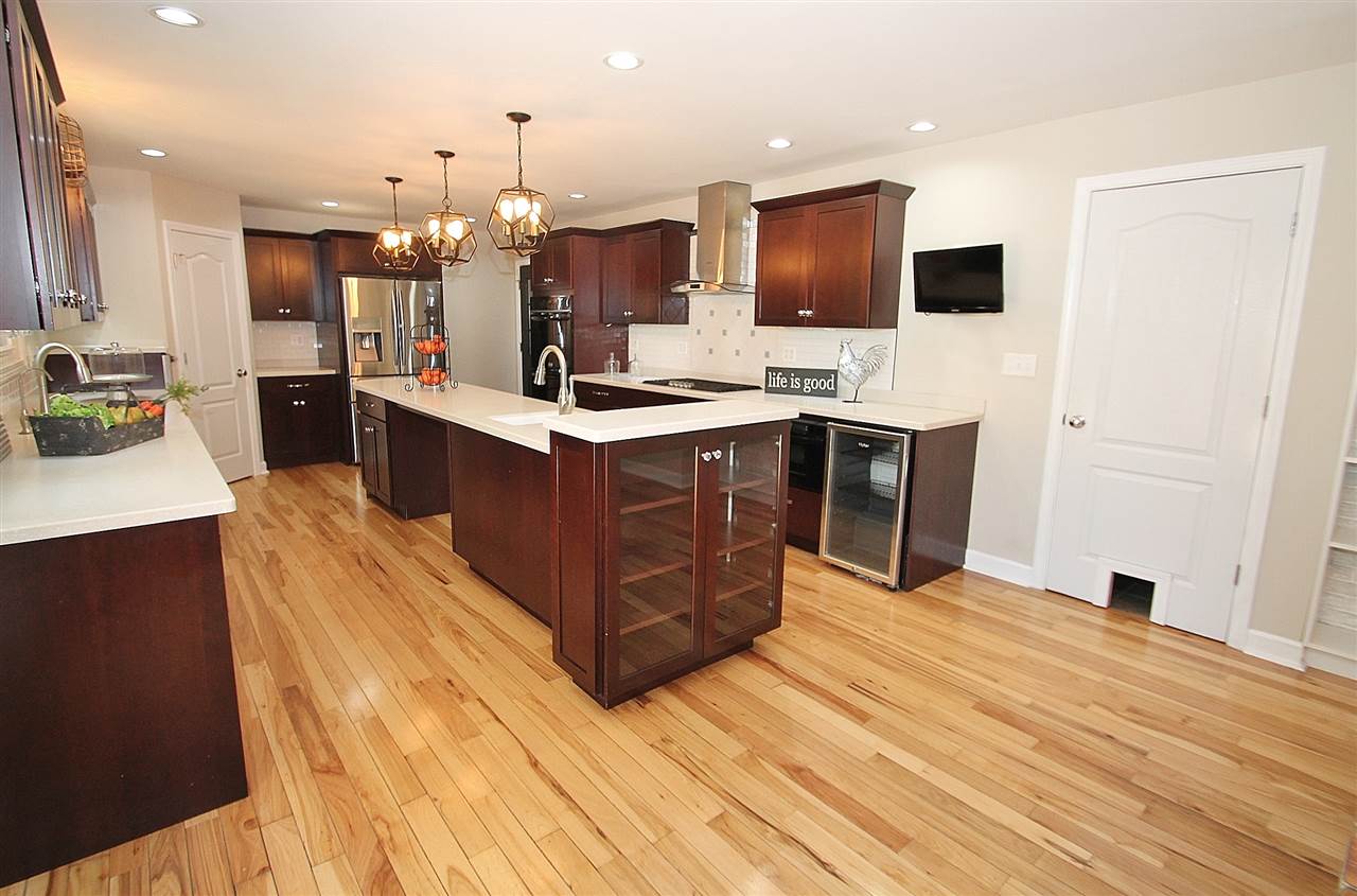 8372 Spring Creek Road Rockford, IL 61114 - Photo 8 of 25 a large kitchen with stainless steel appliances kitchen island granite countertop a stove and a sink