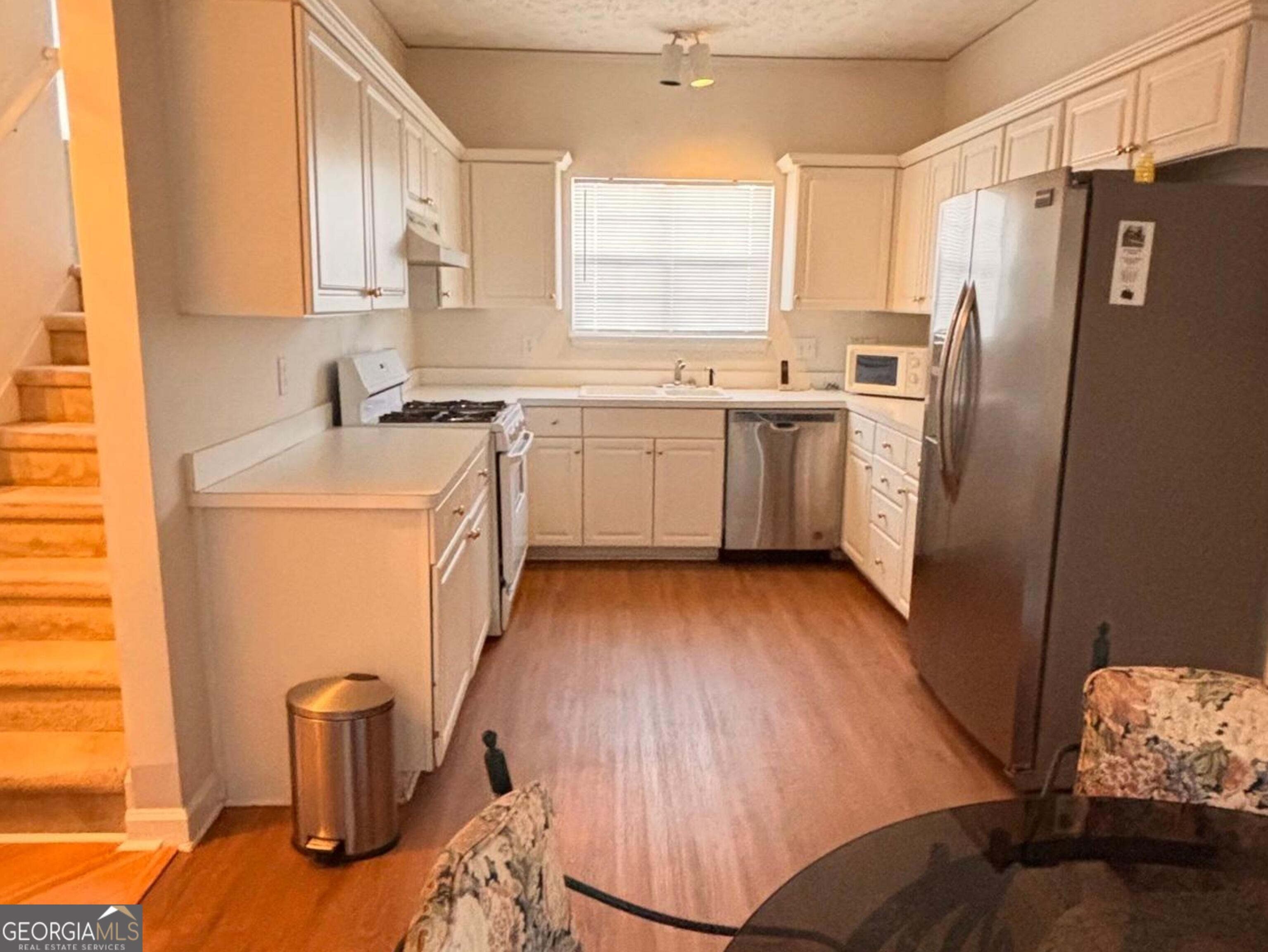 474 Fraser Street Southeast Atlanta, GA 30312 - Photo 17 of 21 a kitchen with a sink refrigerator and window