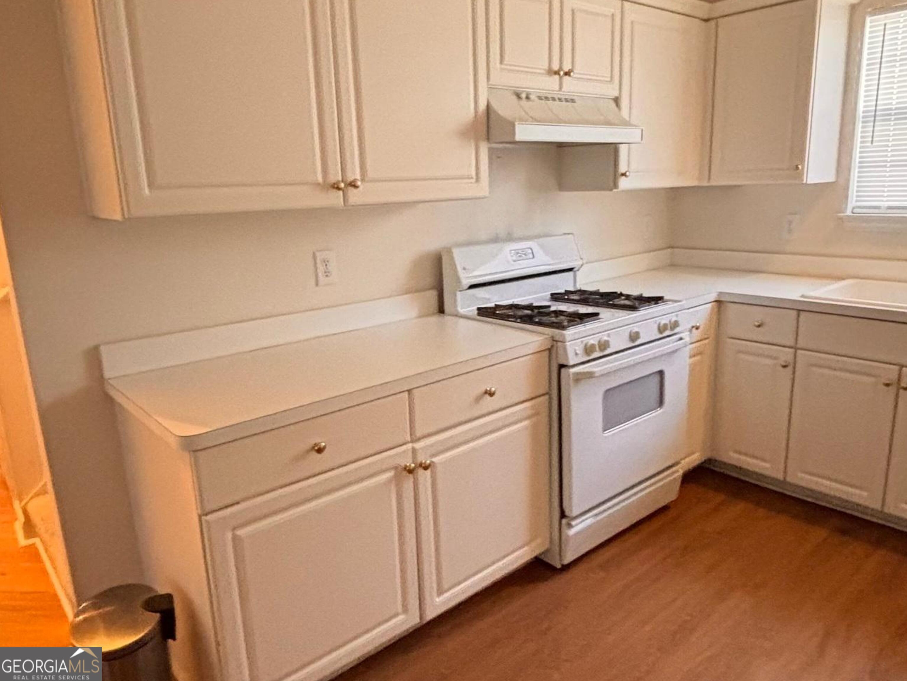 474 Fraser Street Southeast Atlanta, GA 30312 - Photo 18 of 21 a kitchen with granite countertop white cabinets and white appliances