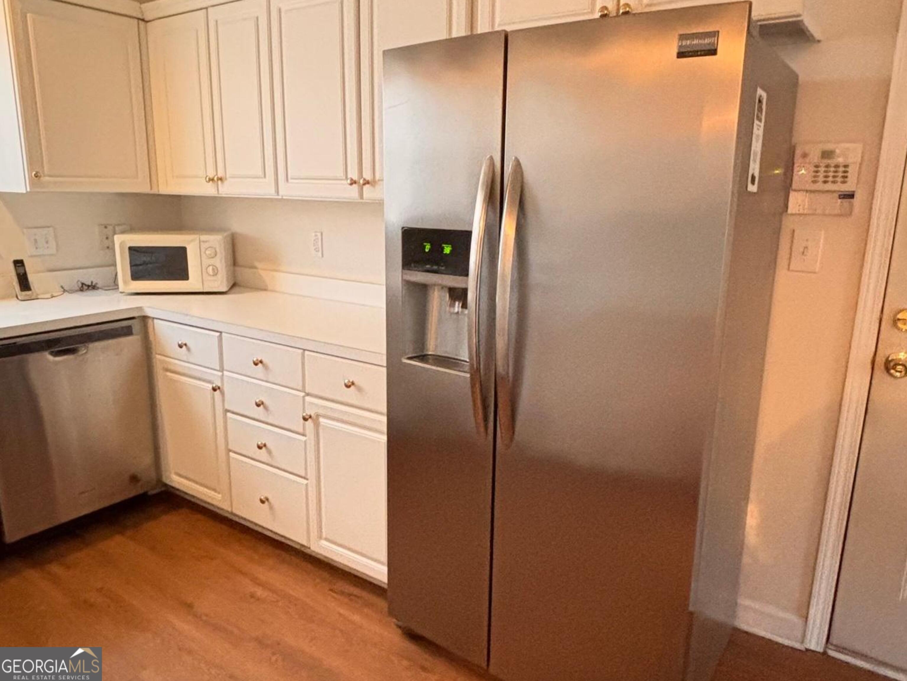 474 Fraser Street Southeast Atlanta, GA 30312 - Photo 20 of 21 a kitchen with cabinets and stainless steel appliances