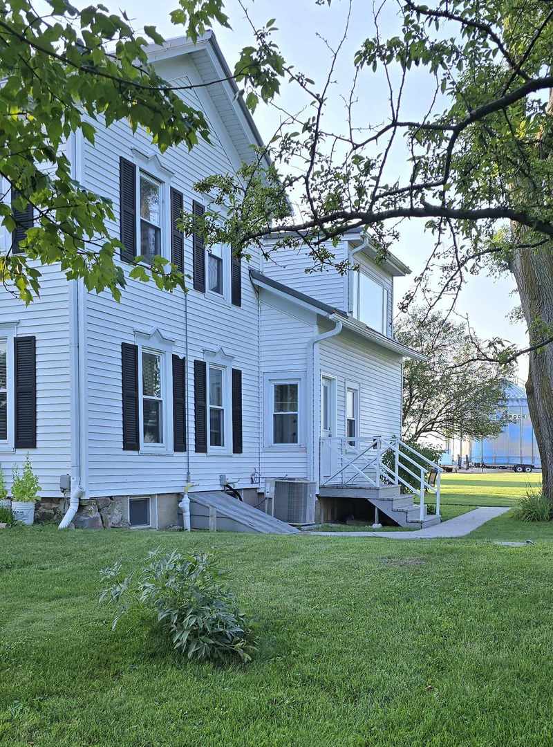 11718 Thayer Road Hebron, IL 60034 - Photo 2 of 14 a view of a house with a yard and a large tree