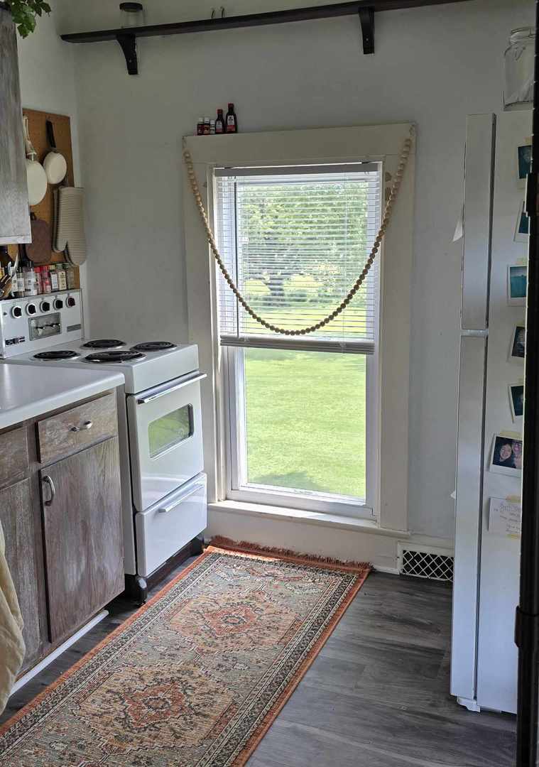 11718 Thayer Road Hebron, IL 60034 - Photo 7 of 14 an entryway with wooden floor and cabinet