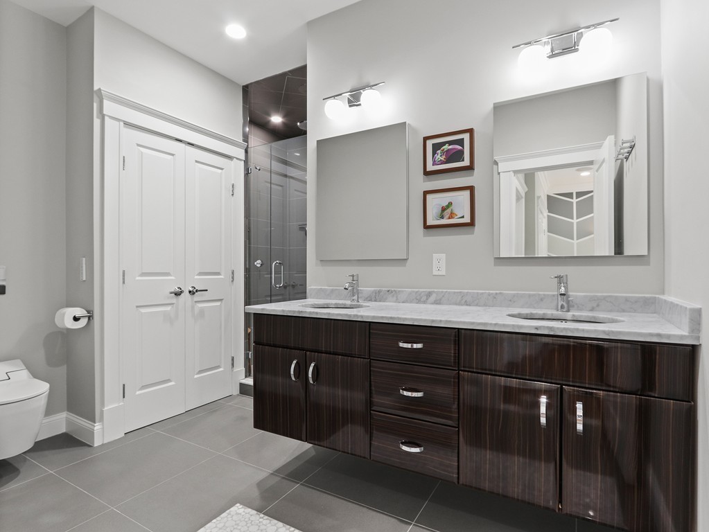 63 Herrick Road, Unit 2 Newton, MA 02459 - Photo 19 of 38 a bathroom with a granite countertop sink mirror and toilet
