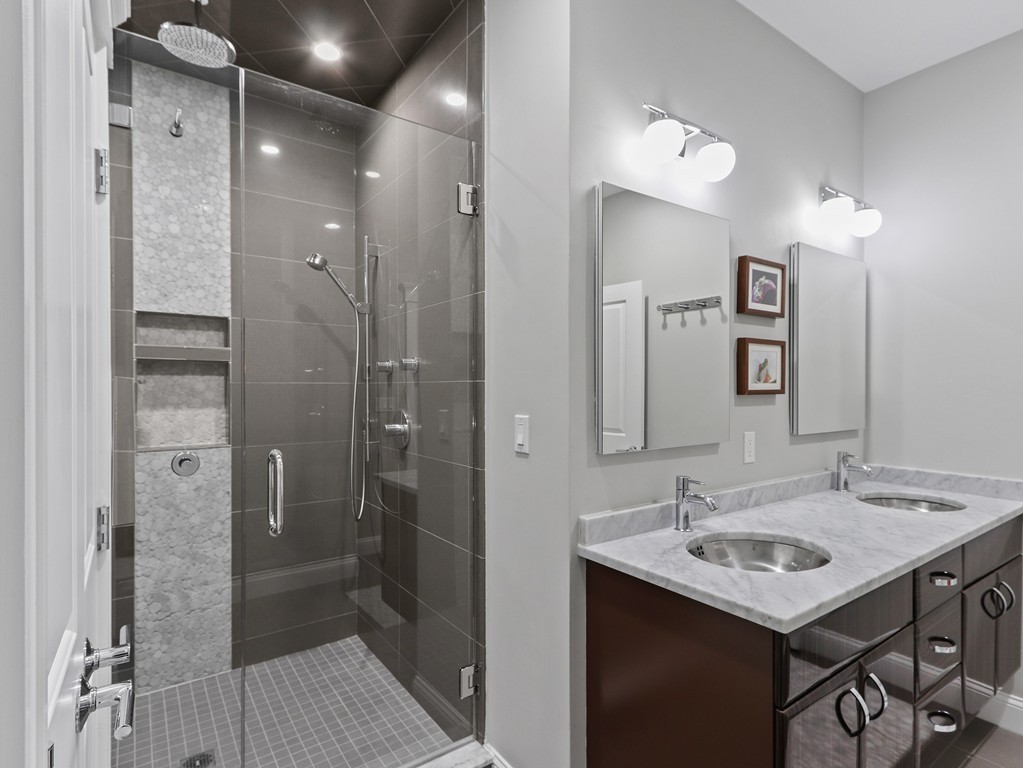 63 Herrick Road, Unit 2 Newton, MA 02459 - Photo 20 of 38 a bathroom with a sink shower and a mirror