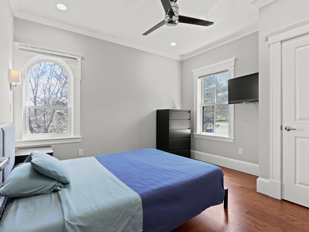 63 Herrick Road, Unit 2 Newton, MA 02459 - Photo 23 of 38 a bedroom with a bed and a flat screen tv