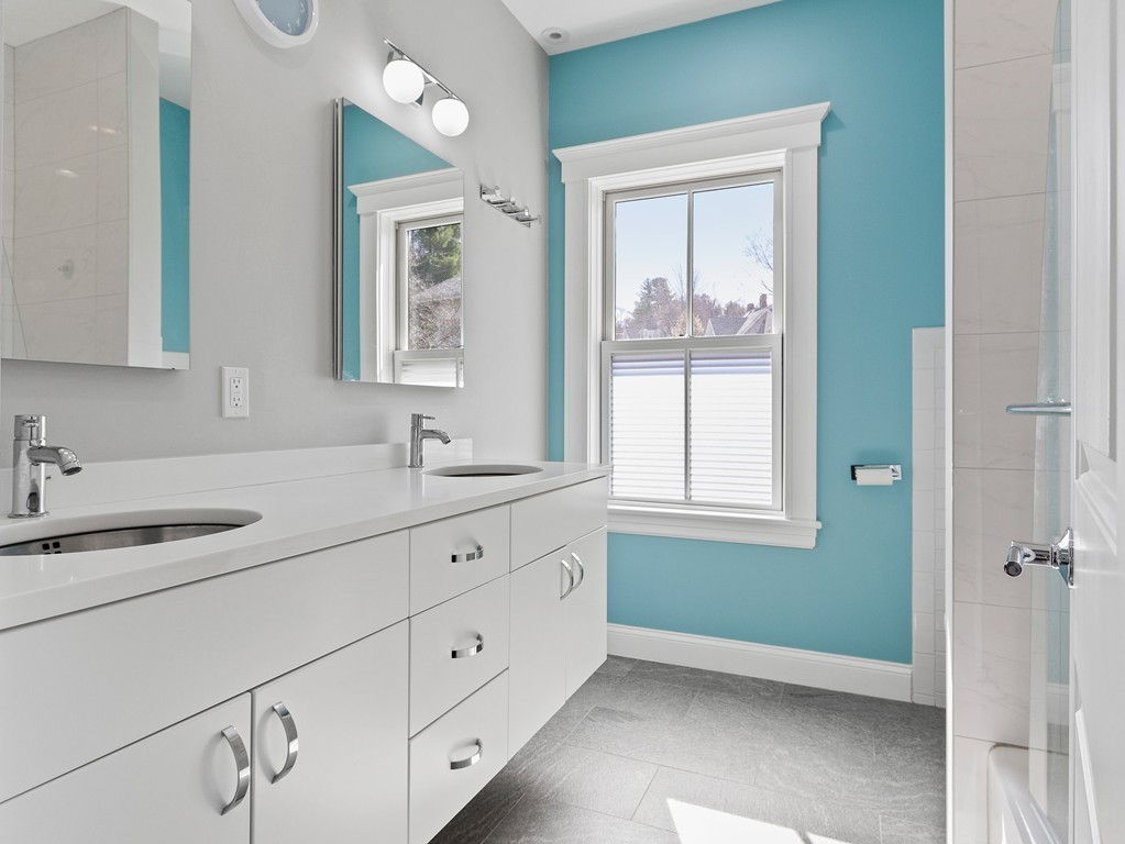 63 Herrick Road, Unit 2 Newton, MA 02459 - Photo 24 of 38 a bathroom with a sink mirror and window