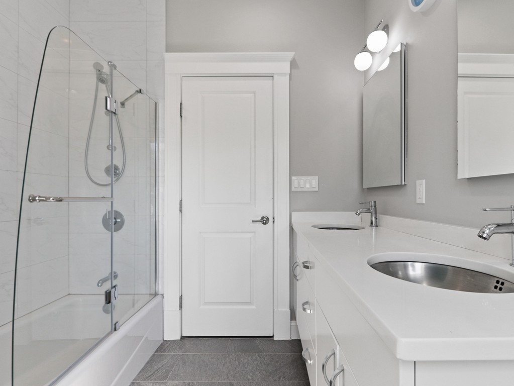 63 Herrick Road, Unit 2 Newton, MA 02459 - Photo 25 of 38 a bathroom with a tub sink and mirror