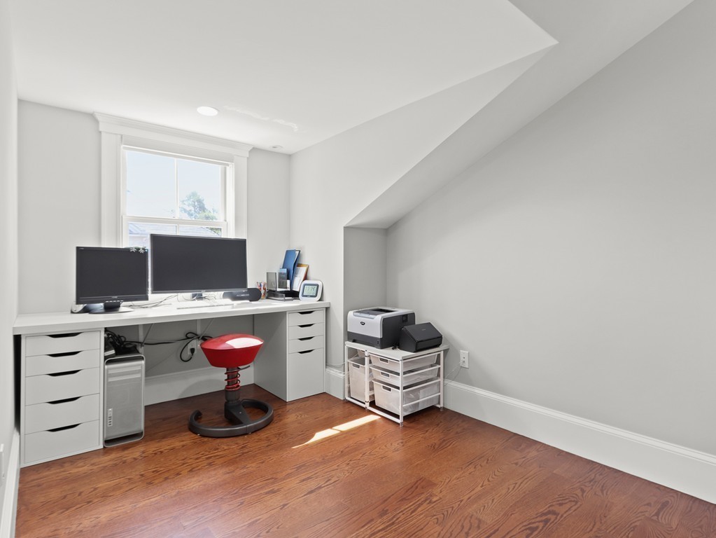 63 Herrick Road, Unit 2 Newton, MA 02459 - Photo 26 of 38 a room with furniture and flat screen tv