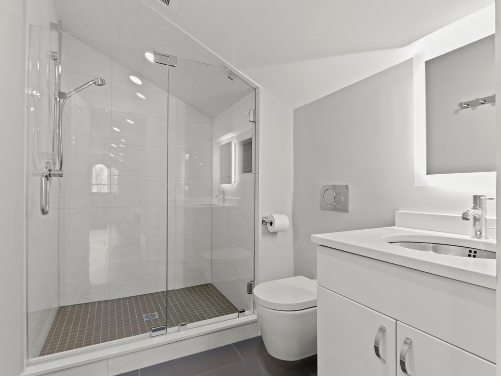 63 Herrick Road, Unit 2 Newton, MA 02459 - Photo 29 of 38 a bathroom with a sink a toilet and shower