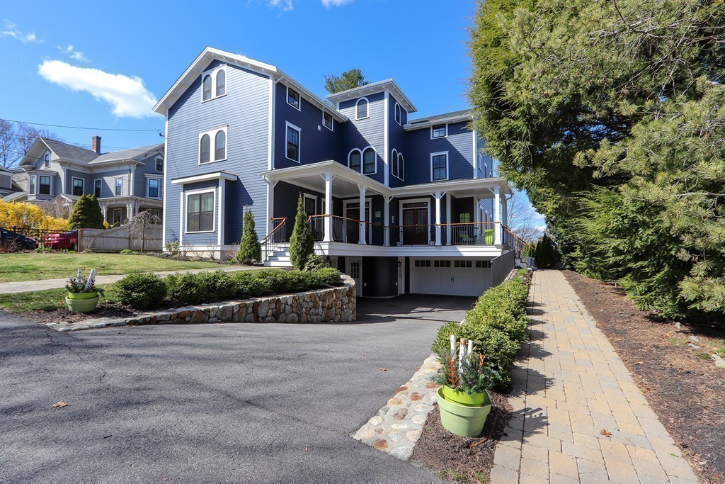 63 Herrick Road, Unit 2 Newton, MA 02459 - Photo 36 of 38 a front view of a house with a yard