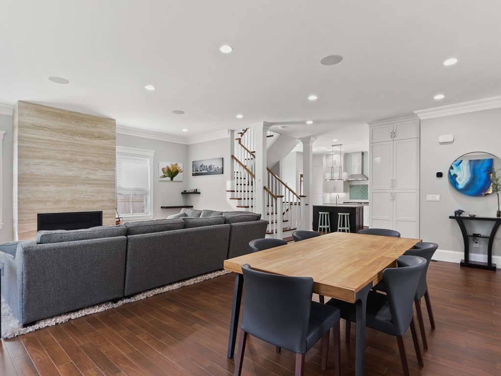 63 Herrick Road, Unit 2 Newton, MA 02459 - Photo 6 of 38 a living room with furniture a table and kitchen view