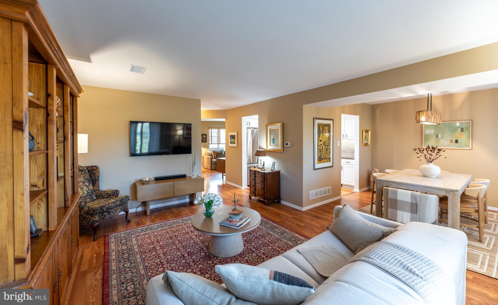 204 Camsten Court Chesterbrook, PA 19087 - Photo 14 of 56 a living room with furniture a flat screen tv and kitchen view
