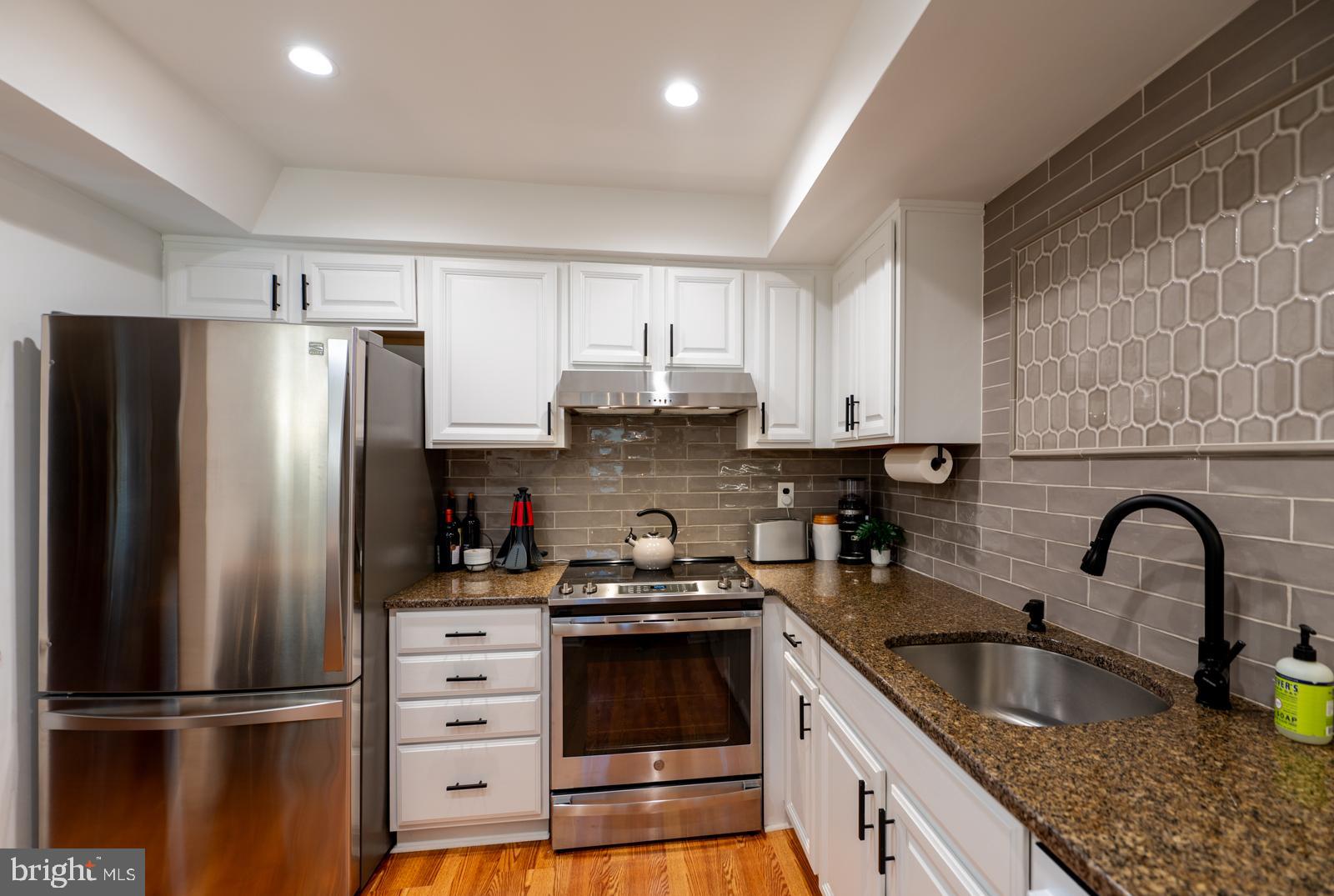 204 Camsten Court Chesterbrook, PA 19087 - Photo 25 of 56 a kitchen with granite countertop a refrigerator and a sink