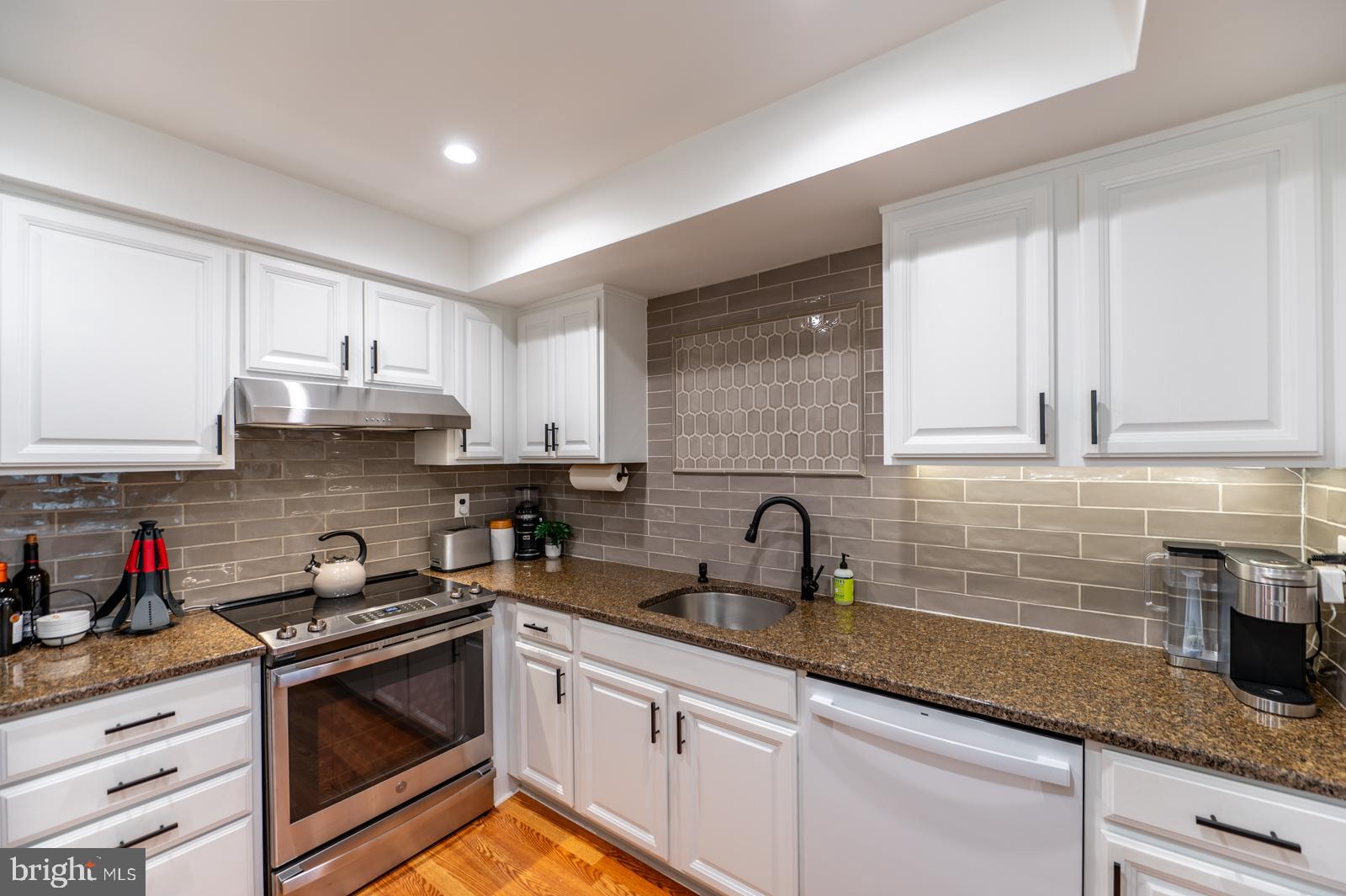 204 Camsten Court Chesterbrook, PA 19087 - Photo 27 of 56 a kitchen with granite countertop white cabinets sink and stainless steel appliances