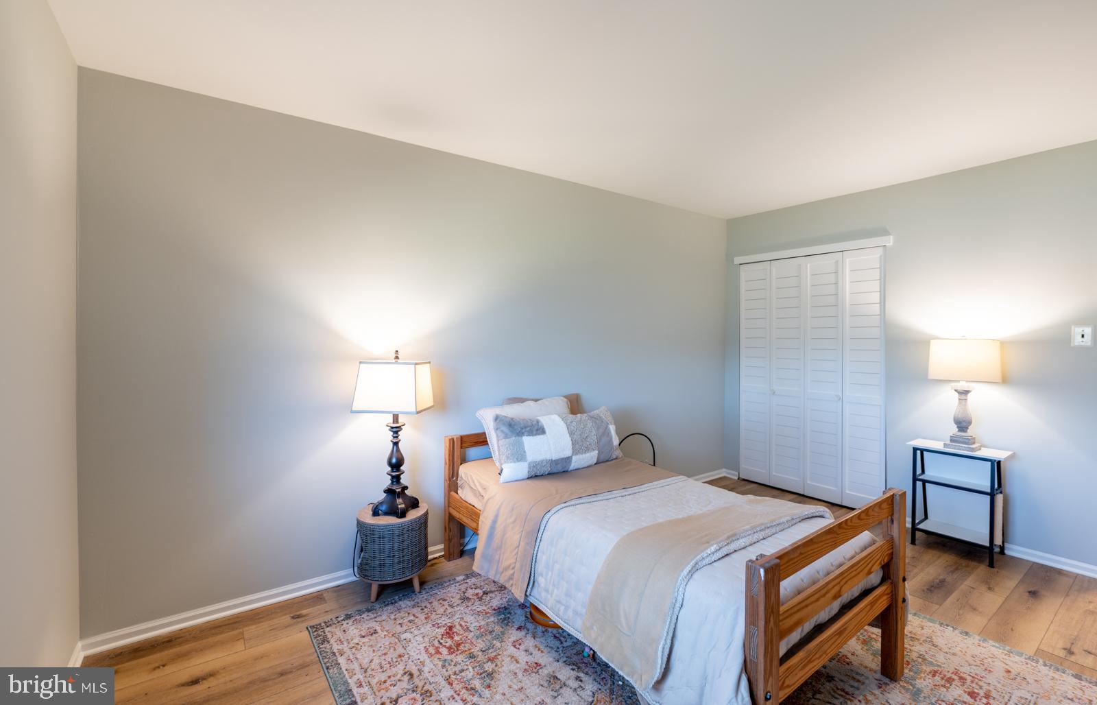 204 Camsten Court Chesterbrook, PA 19087 - Photo 51 of 56 a bedroom with a bed and a lamp