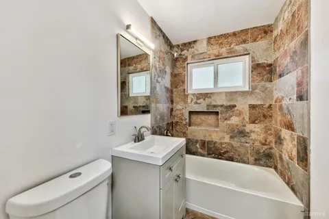 a bathroom with a sink toilet and shower