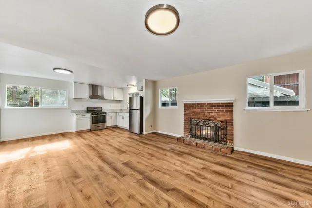 a view of kitchen with granite countertop cabinets and window