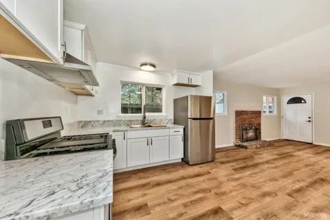 a kitchen with a refrigerator and a stove top oven