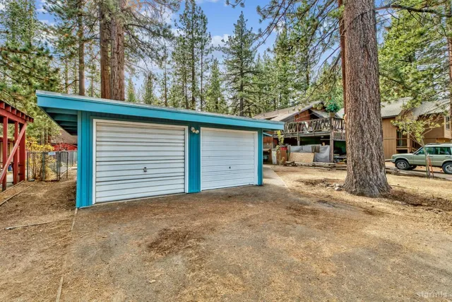 a view of a house with a yard and garage