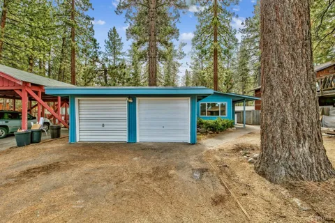 a view of a house with a tree in the background