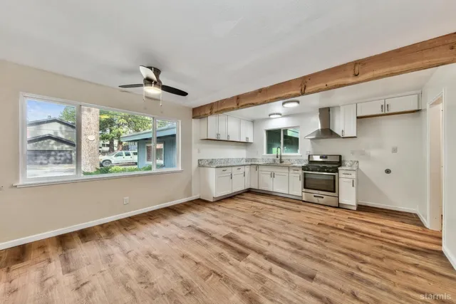 a kitchen with stainless steel appliances a stove top oven a sink and a refrigerator