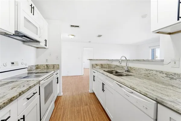 a kitchen with a sink and cabinets