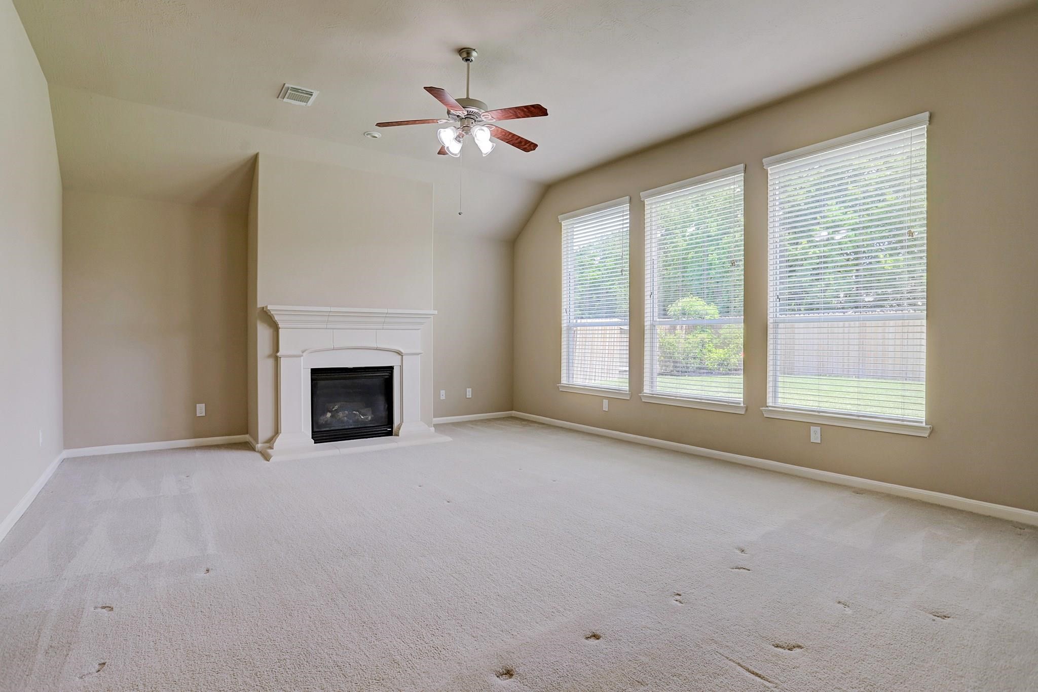 2118 Great Prairie Lane Katy, TX 77494 - Photo 12 of 24 an empty room with chandelier fan and windows
