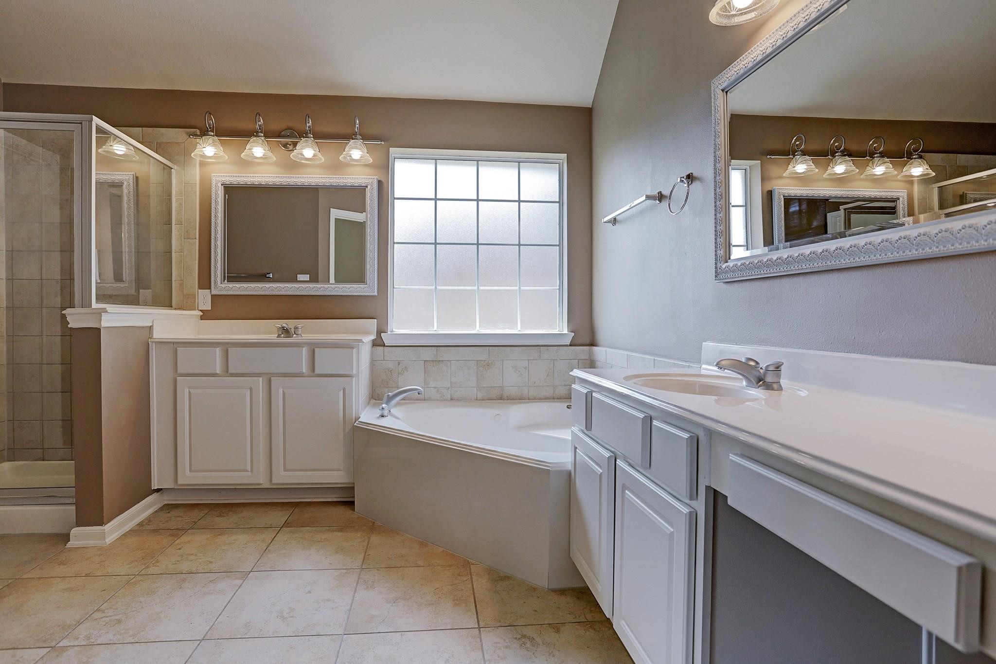 2118 Great Prairie Lane Katy, TX 77494 - Photo 16 of 24 a bathroom with a tub sink and mirror