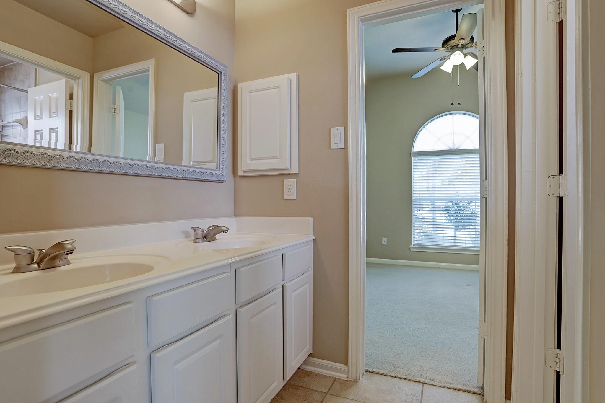 2118 Great Prairie Lane Katy, TX 77494 - Photo 21 of 24 a bathroom with a sink and a mirror