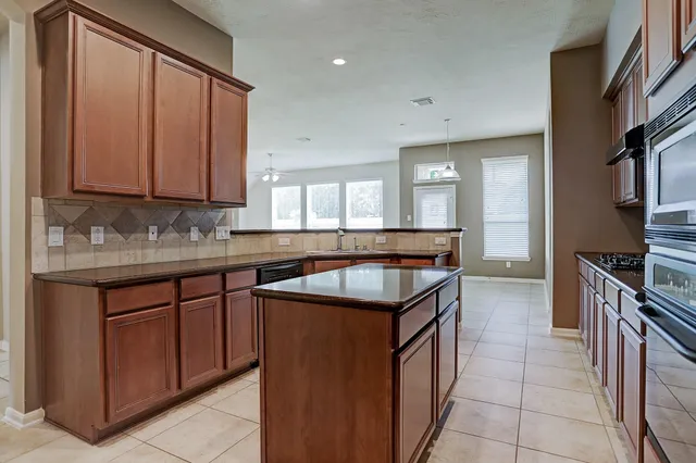 a kitchen with a sink stove and cabinets