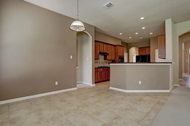 a view of a kitchen with a refrigerator wooden floor and a kitchen