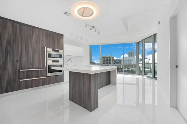 a kitchen with stainless steel appliances a stove refrigerator and cabinets
