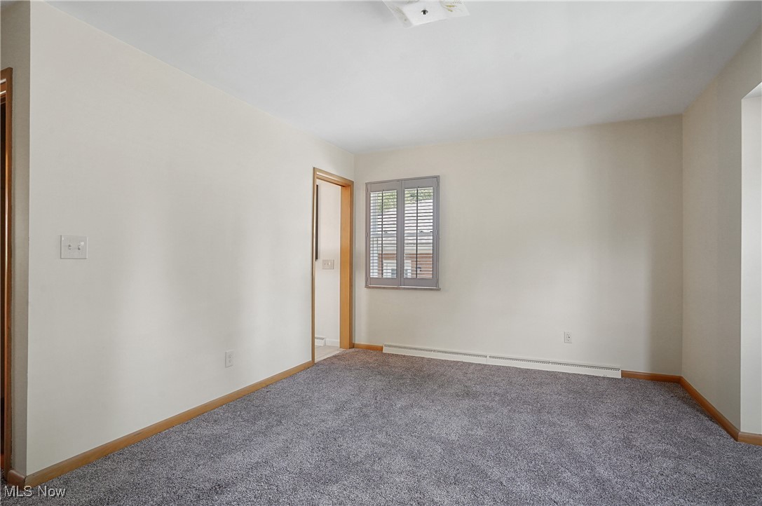 3215 Stanley Road Akron, OH 44333 - Photo 21 of 30 Unfurnished room featuring carpet floors and a baseboard radiator