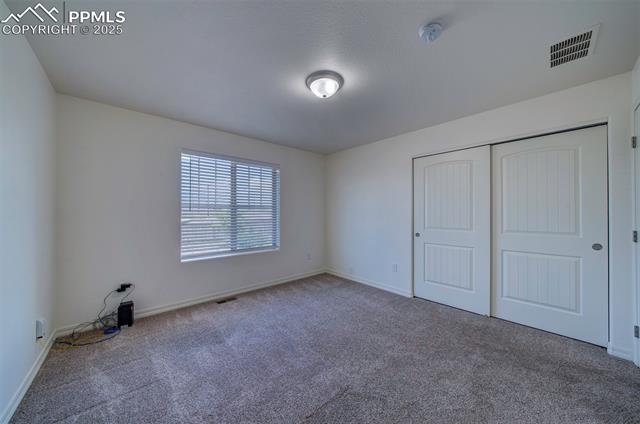 6604 Watusi Road Peyton, CO 80831 - Photo 21 of 40 Unfurnished bedroom featuring carpet flooring and a closet