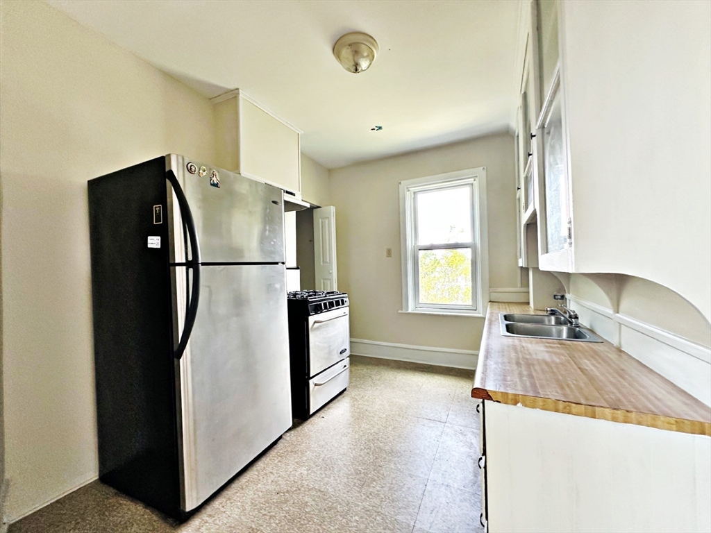 528 Lawton Street, Unit 3 Fall River, MA 02721 - Photo 12 of 22 a kitchen with a refrigerator and a sink