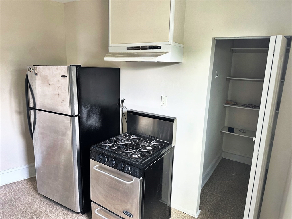 528 Lawton Street, Unit 3 Fall River, MA 02721 - Photo 13 of 22 a kitchen with a refrigerator and a stove