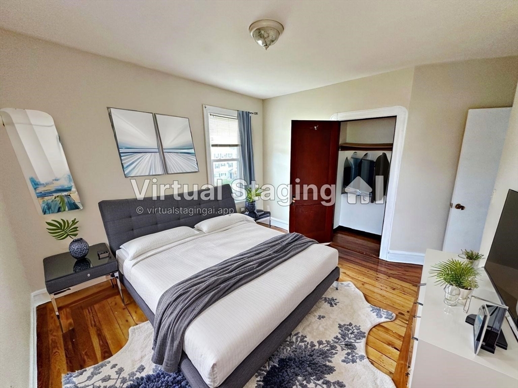 528 Lawton Street, Unit 3 Fall River, MA 02721 - Photo 14 of 22 a bedroom with a bed and wooden floor