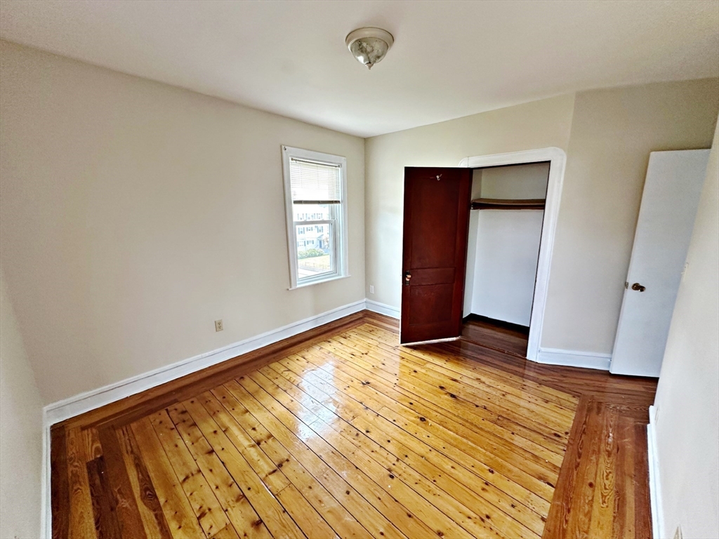 528 Lawton Street, Unit 3 Fall River, MA 02721 - Photo 15 of 22 a view of an empty room with wooden floor and a window