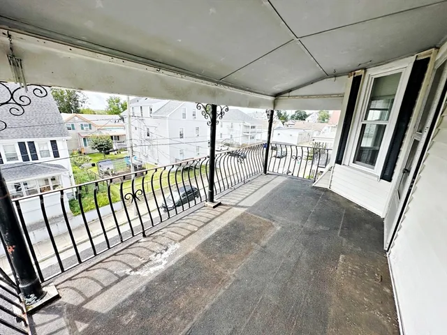 a view of a porch with wooden floor