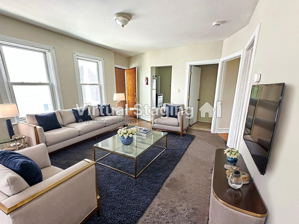 528 Lawton Street, Unit 3 Fall River, MA 02721 - Photo 9 of 22 a living room with furniture and a flat screen tv