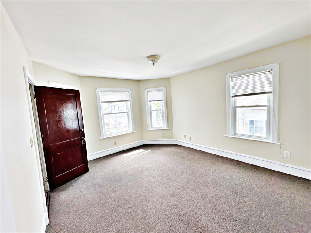 528 Lawton Street, Unit 3 Fall River, MA 02721 - Photo 10 of 22 an empty room with windows and closet