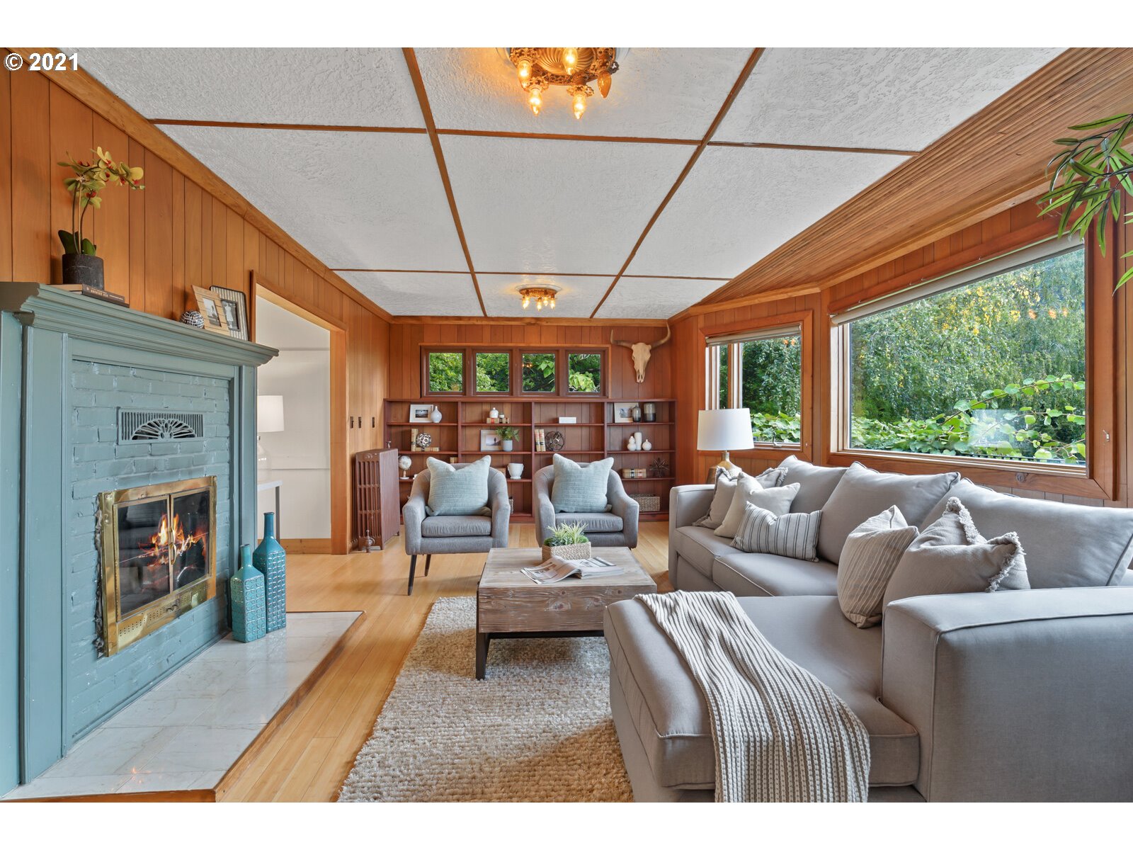 3748 Southwest Patton Road Portland, OR 97221 - Photo 14 of 32 a living room with furniture a fireplace and a floor to ceiling window