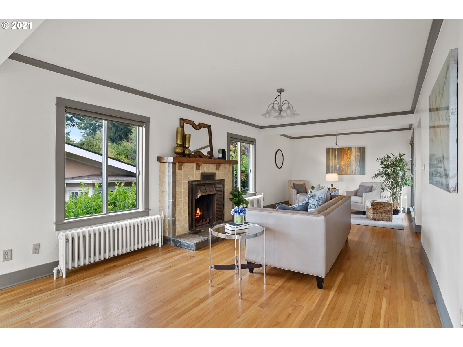 3748 Southwest Patton Road Portland, OR 97221 - Photo 5 of 32 a living room with furniture a fireplace and a large window