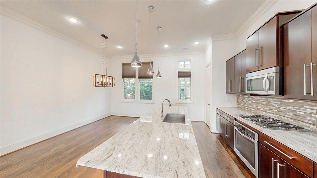 620 South Pearl Expressway Dallas, TX 75201 - Photo 11 of 33 a large kitchen with stainless steel appliances a large counter top a stove and a refrigerator